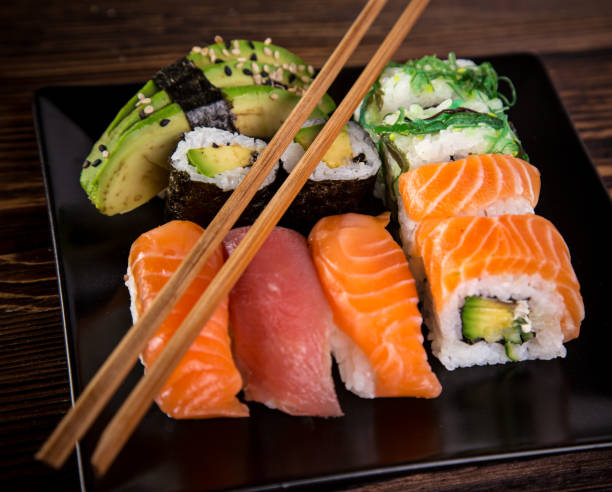 istock Various kinds of sushi served on wooden table 856984830