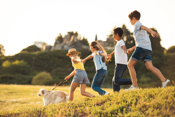 istock teenagers with dog in park 856984894