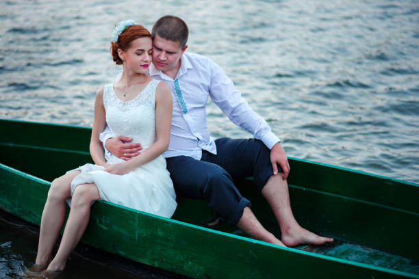 young couple in love sitting in a small boat and having fun.