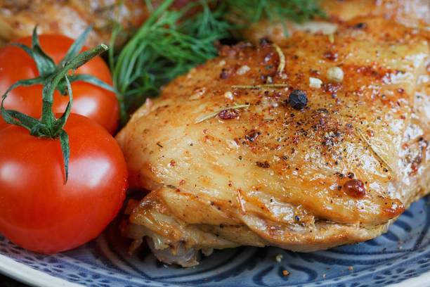 istock Roasted chicken and vegetables on wooden background 856989054