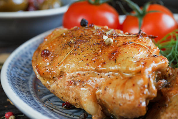 istock Roasted chicken and vegetables on wooden background 856989066