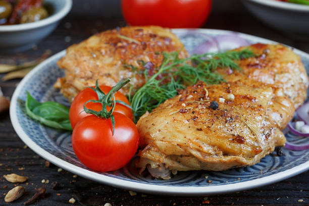istock Roasted chicken and vegetables on wooden background 856989068