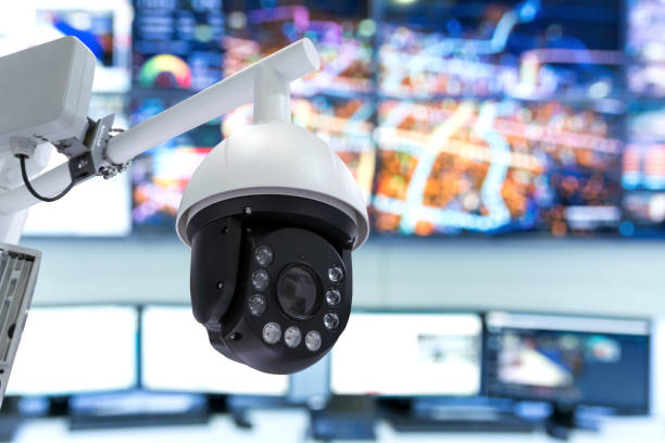 istock Smart city technology concept. Security camera for monitoring everything in city with control monitoring room background. 856990052