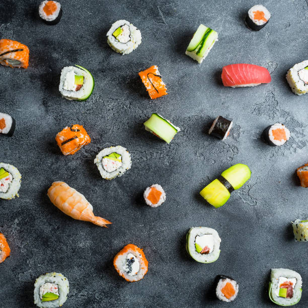 istock Pattern of sushi rolls on a dark background. Japanese food. Flat lay. Top view 856990070