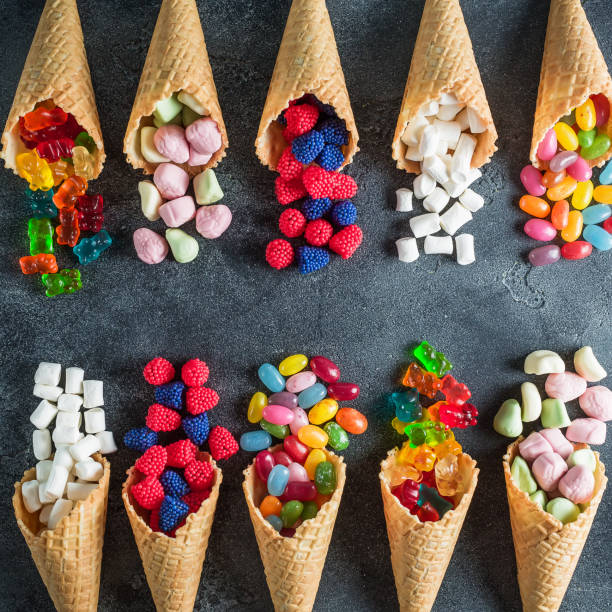 istock Assorted candy in waffle cones. Summer concept, food frame. Flat lay, top view 856992552