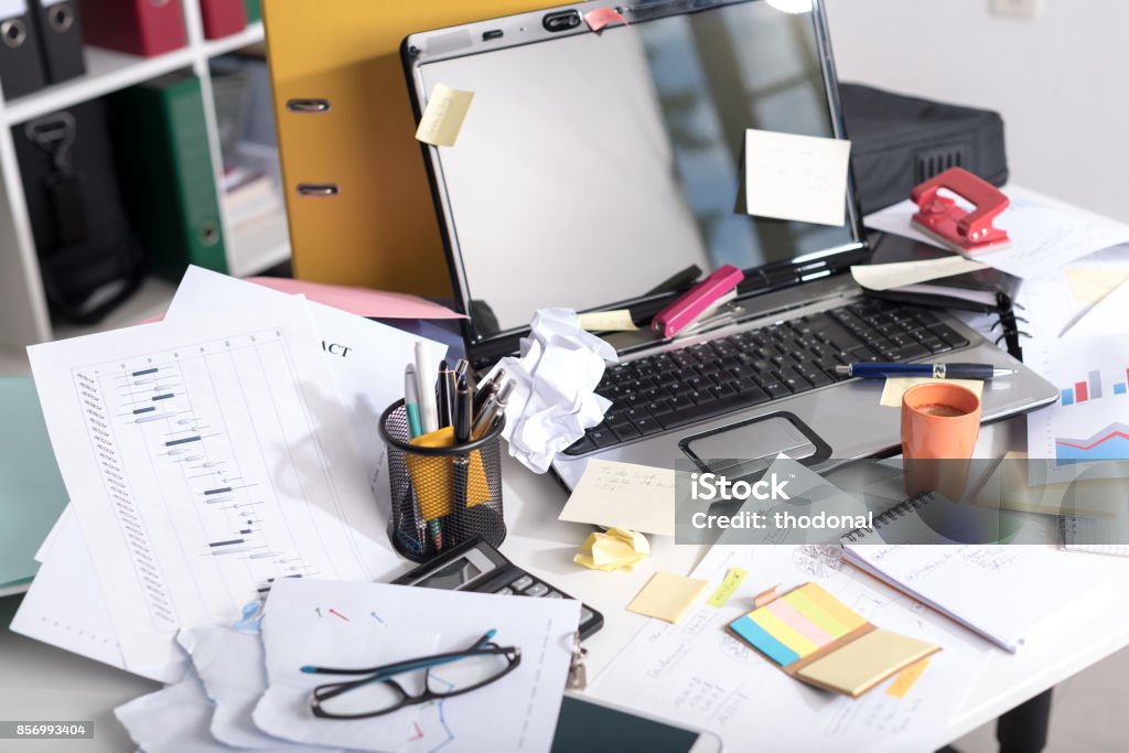 Messy and cluttered desk Messy and cluttered office desk Messy Stock Photo