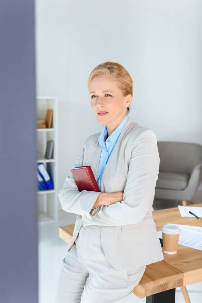 istock mature businesswoman with book 856996796