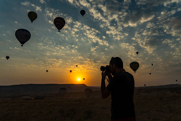 istock Man taking picture of Hot air balloons 856997140