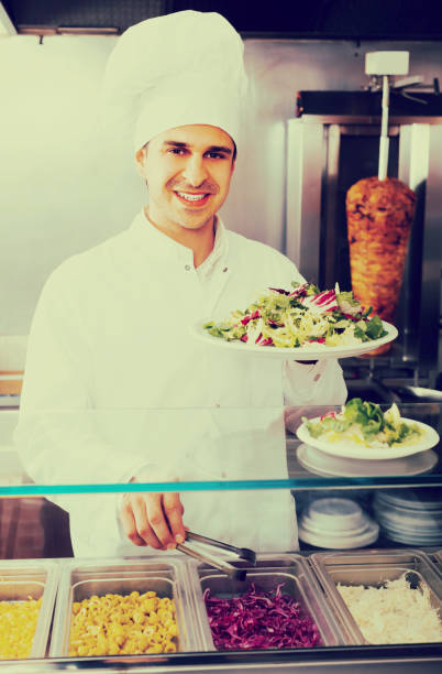 istock Happy male chef with vegetables 857001114
