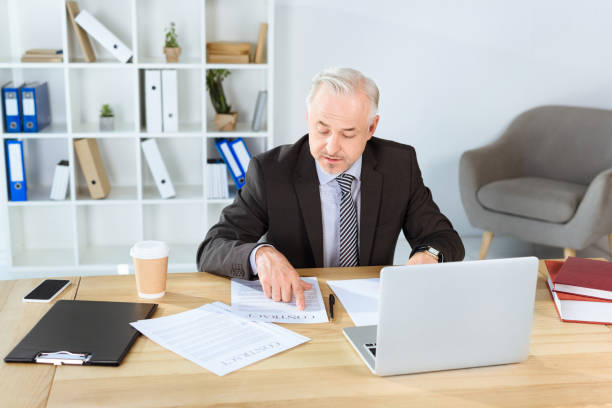 istock mature businessman with paperwork 857001442