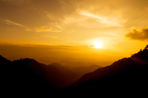 Orange Sunset shine on sky and mountain in evening time