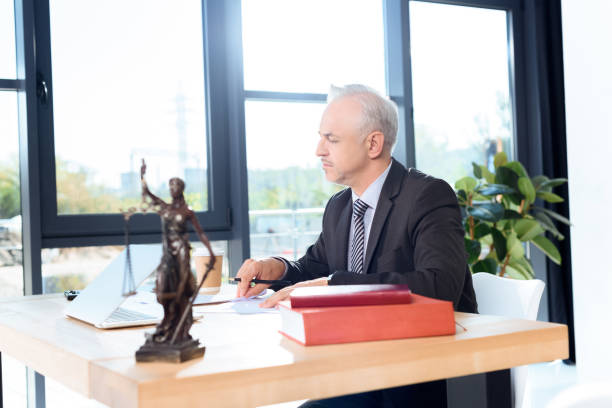 istock mature lawyer sitting at workplace 857005936