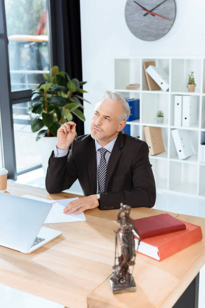istock mature lawyer sitting at workplace 857008366