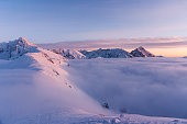 Mountain peaks in the setting sun during inversion. Tatra Mountains.