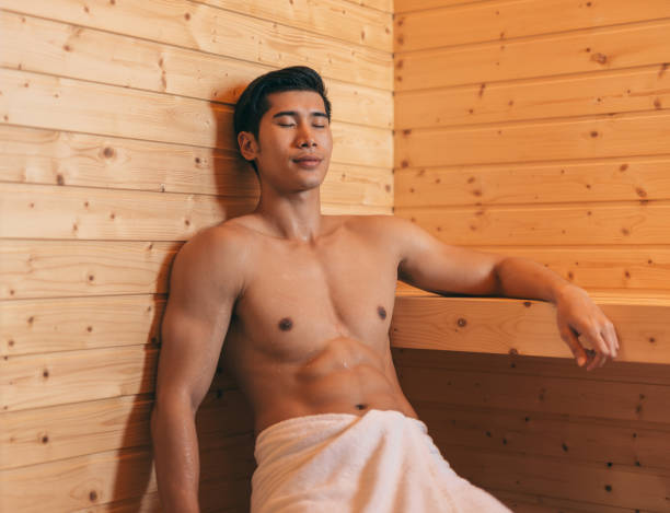 happy good looking and attractive young asian man with muscular body relaxing in sauna hot - asian ethnicity fashion model beautiful luxury imagens e fotografias de stock