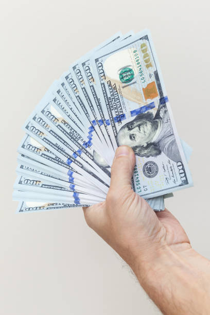 istock Vertical photo. Fan of One Hundred Dollars notes 857015300