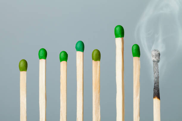 wooden matches with green head poured into cardboard boxes close up, the green head of a wooden match laid out in cardboard boxes