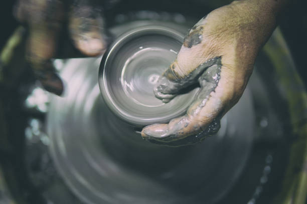 istock Man potter making ceramic pot on the pottery wheel 857015710