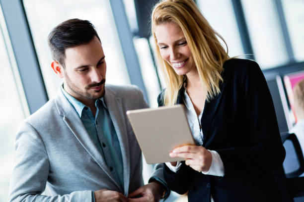 istock Attractive business couple using tablet in their company 857017752