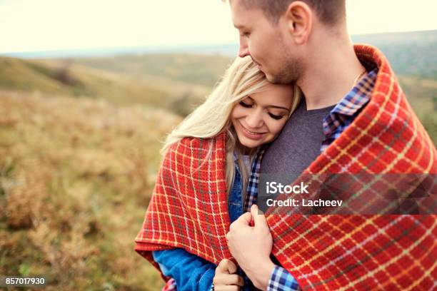 Happy Couple Under A Plaid Outdoors Stock Photo - Download Image Now - Active Lifestyle, Adult, Adults Only