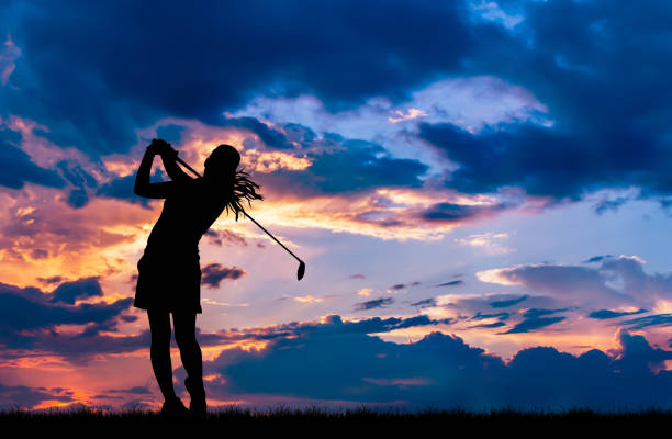 istock silhouette golfer playing golf during beautiful sunset 857031524
