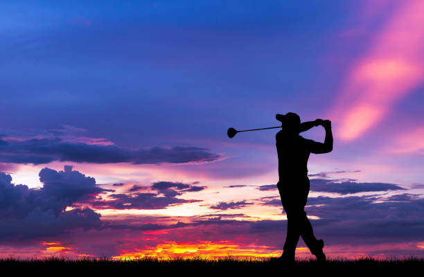 istock silhouette golfer playing golf during beautiful sunset 857031760
