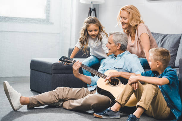 istock family playing on guitar 857031984