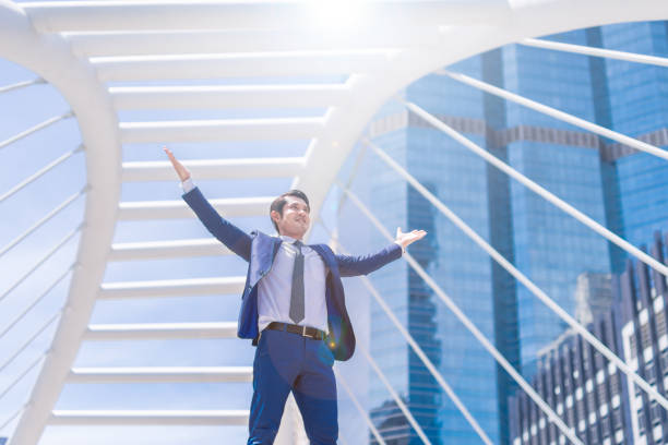 istock Celebrating success businessman keeping arms raised 857032192