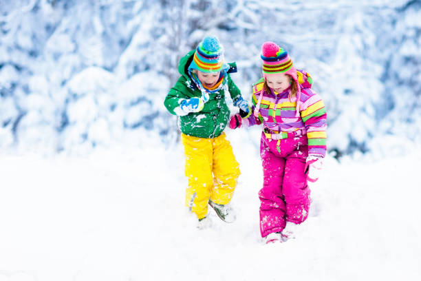 istock Kids playing in snow. Children play outdoors in winter snowfall. 857037164