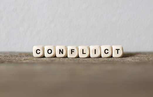 Word CONFLICT made with wood building blocks,stock image