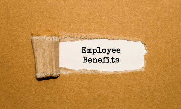 istock The text Employee Benefits appearing behind torn brown paper 857037338