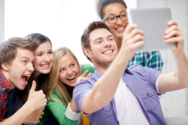 istock group of happy high school students with tablet pc 857037492