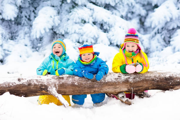 istock Kids playing in snow. Children play outdoors in winter snowfall. 857037552