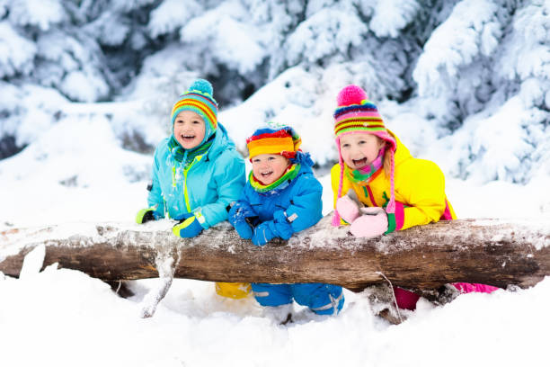 istock Kids playing in snow. Children play outdoors in winter snowfall. 857038046