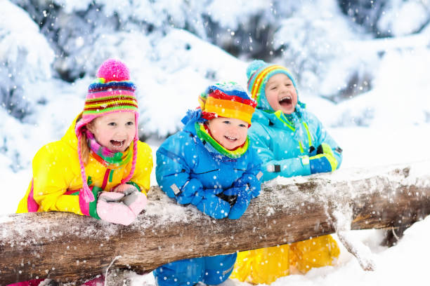 istock Kids playing in snow. Children play outdoors in winter snowfall. 857038236