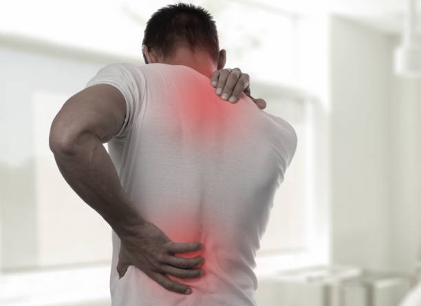 Muscular Man suffering from back and neck pain. Incorrect sitting posture problems Muscle spasm, rheumatism. Pain relief, ,chiropractic concept. Sport exercising injury stock photo