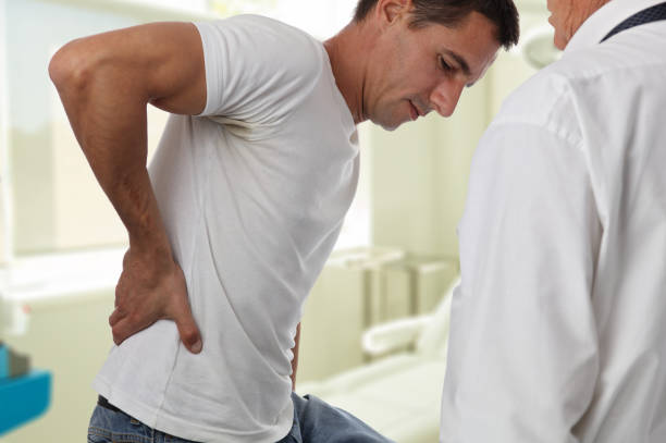 istock Muscular Man suffering from back and neck pain. Incorrect sitting posture problems Muscle spasm, rheumatism. Pain relief, ,chiropractic concept. Sport exercising injury 857040792