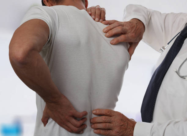 istock Muscular Man suffering from back and neck pain. Incorrect sitting posture problems Muscle spasm, rheumatism. Pain relief, ,chiropractic concept. Sport exercising injury 857040912