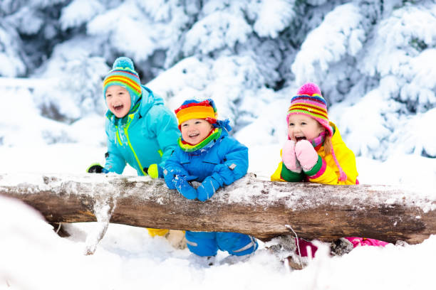 istock Kids playing in snow. Children play outdoors in winter snowfall. 857041050