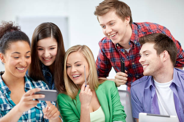 istock group of happy students with smartphone at school 857041266