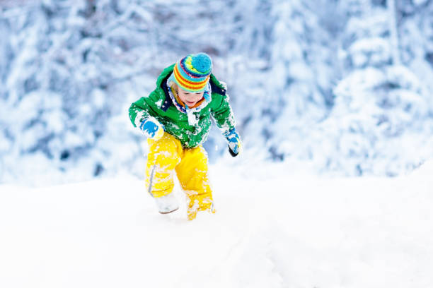 bambino che gioca con la neve in inverno. bambini all'aperto. - 13431 foto e immagini stock