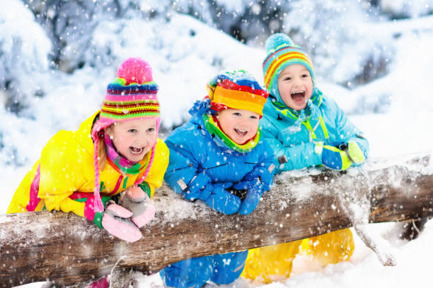 istock Kids playing in snow. Children play outdoors in winter snowfall. 857044928
