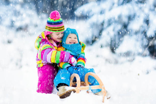 kids on sleigh ride. children sledding. winter snow fun. - 13448 imagens e fotografias de stock