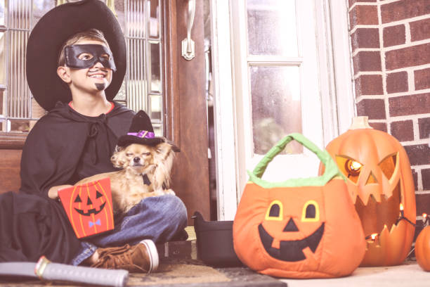 istock Little boy, pet dog at front door on Halloween. 857048780