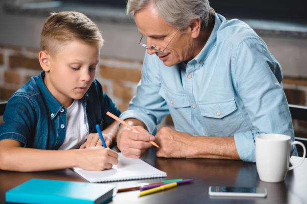 istock grandfather and grandson drawing together 857049600