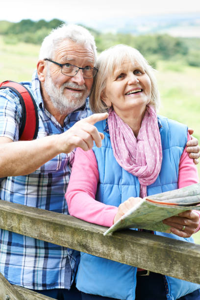 istock Senior Couple Hiking In Countryside With Map 857052164