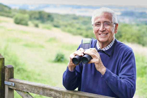 istock Portrait Of Senior Man On Walk With Binoculars 857052488