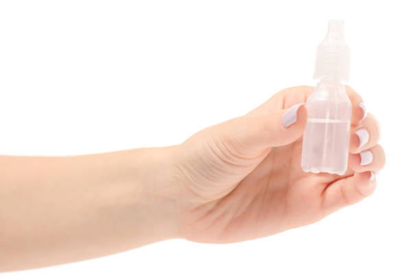 istock Female hand drops for a nose 857052502