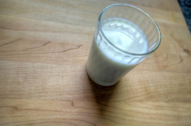 istock A glass of milk on a wood table 857053360