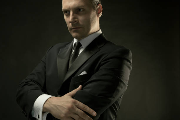 istock The attractive man in black suit on dark background 857053748